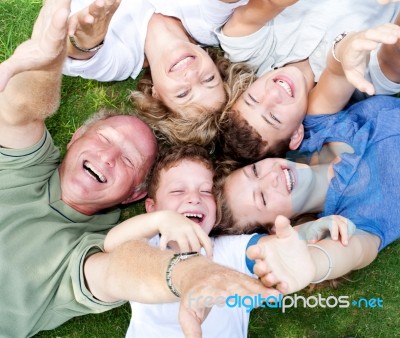 Happy Family Lying As A Circle Stock Photo