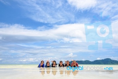 Happy Family Lying Together On The Beach, Thailand Stock Photo