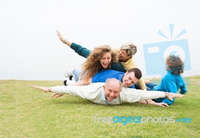 Happy Family Playing At Park Stock Photo