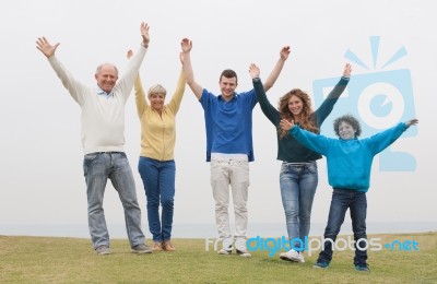 Happy Family Raised Their Hands Stock Photo