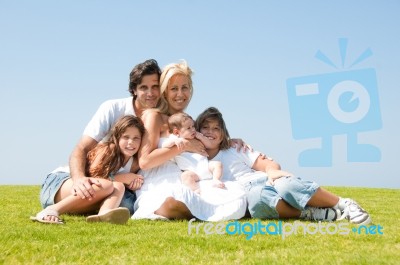 Happy Family Relaxing In Garden Stock Photo