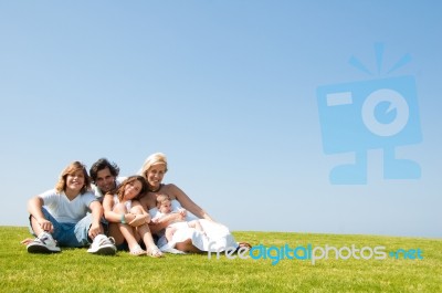 Happy Family Relaxing In Garden Stock Photo