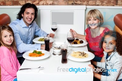 Happy Family Together In A Restaurant Stock Photo