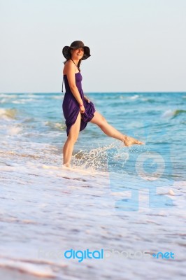 Happy Girl Playing With Water In The Sea Stock Photo
