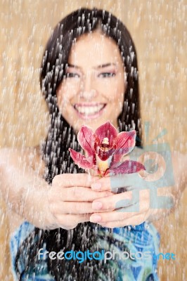Happy Girl With Red Orchid Stock Photo