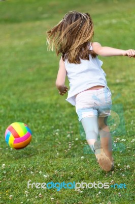 Happy Little Girl Playing Ball In The Park Stock Photo