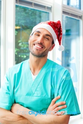 Happy Male Surgeon Wearing Santa Hat Stock Photo
