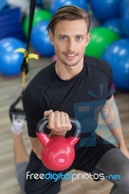 Happy Man Doing Stretching Exercises In A Health Club Stock Photo