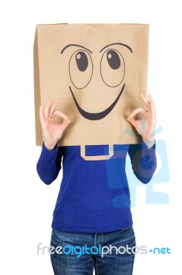 Happy Smiling Woman With Paper Bag On Head Stock Photo