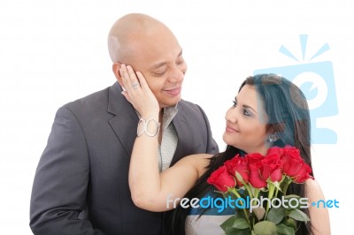 Happy Woman Receiving A Bouquet Of Red Roses Of Her Lover Stock Photo