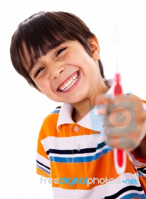 Happy Young Boy Showing The Toothbrush Stock Photo