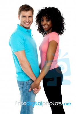 Happy Young Couple Holding Hands Stock Photo