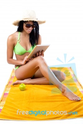 Happy Young Girl With Green Bikini And Digital Table Stock Photo