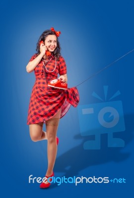 Happy Young Pinup Standing Woman Talking On Phone Stock Photo