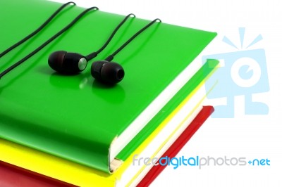 Headphones And Stack Of Multicolored Books On A White Background… Stock Photo