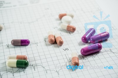 Heap Of Medicine Pills On Cardiogram Grid Paper. Selective Focus… Stock Photo