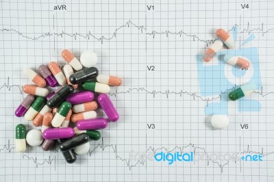 Heap Of Medicine Pills On Cardiogram Grid Paper. Selective Focus… Stock Photo