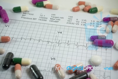 Heap Of Medicine Pills On Cardiogram Grid Paper. Selective Focus… Stock Photo