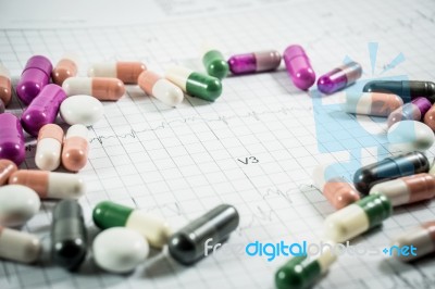 Heap Of Medicine Pills On Cardiogram Grid Paper. Selective Focus… Stock Photo