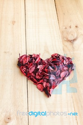 Heart Formed By Red Rose Petals On Wooden Background Stock Photo