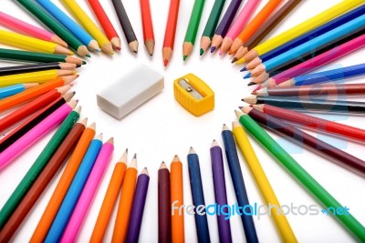 Heart Shape Made Out Of Pencils With Eraser And Pencil Sharpener In The Middle On White Background Stock Photo
