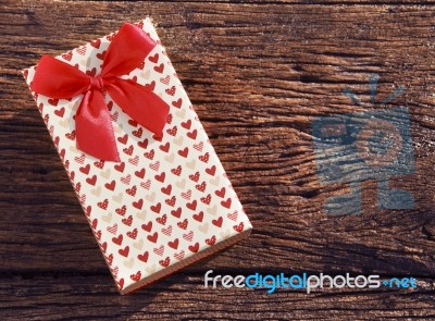 Heart Spot Present Gift Box With Red Ribbon On Old Wood Texture Stock Photo