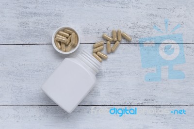 Herb Capsule With White Plastic Container Stock Photo