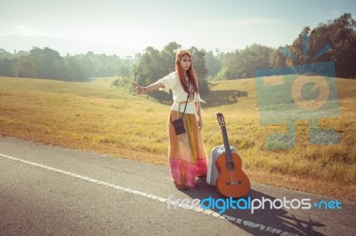 Hippie Girl Hitchhiking Stock Photo