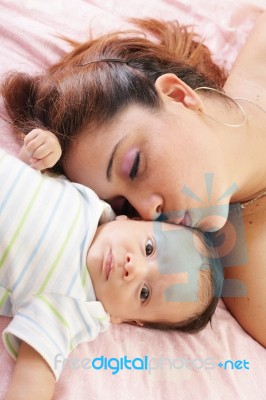 Hispanic Woman Kissing Newborn Stock Photo