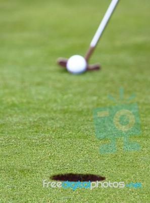 Hitting Golf Ball Into Hole Stock Photo