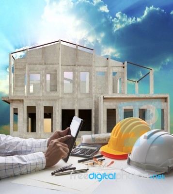 Home Construction And Hand Hold Tablet On Engineer Working Table Use For Real Estate And Construction Business Stock Photo