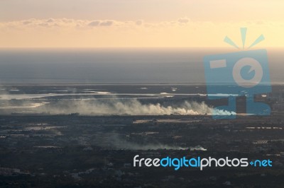 Horizon View Coastline With Smoke From Fire Stock Photo