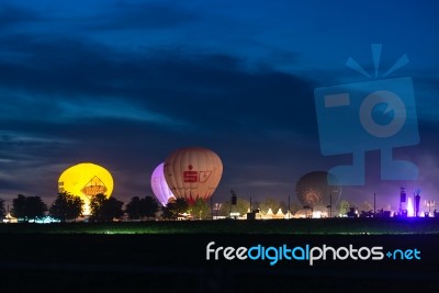 Hot Air Ballons And Tents In The Evening During A Festival Stock Photo