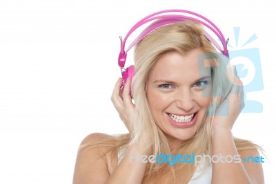 Hot Blonde Listening To Music Via Headphones Stock Photo