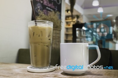 Hot Coffee And Iced Coffee On Wooden Table Stock Photo