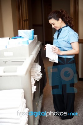 Housekeeper Folding Towel Stock Photo