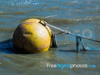 Huge Yellow Buoy Floating In The River Thames Stock Photo