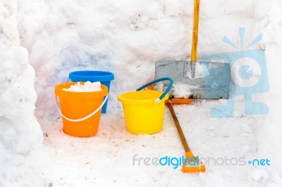 Hut With Walls Of Snow And Colorful Buckets Plus Snowplow Stock Photo
