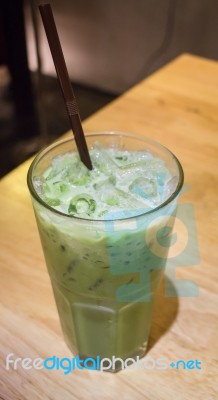 Ice Milk Green Tea On Wooden Table Stock Photo