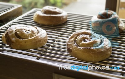 Iced Cinnamon Rolls On Shelf Stock Photo