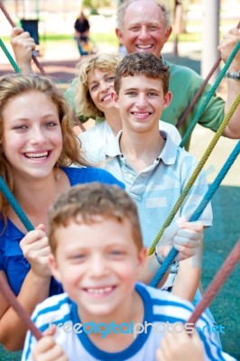 Image Of Portrait Of A Happy Family Swinging In A Line Stock Photo