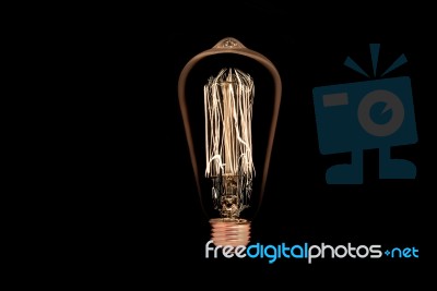 Incandescent Light Bulb On Black Background Stock Photo