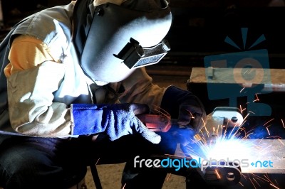 Industrial Worker Welding In Factory Stock Photo