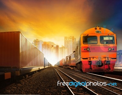 Industries Container Trainst And Boxcar On Track Against Building In Town Background For Industrial Logistic And Land Transportation Stock Photo