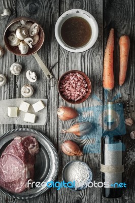 Ingredients For Boeuf Bourguignon On The Old Wooden Table Top View Stock Photo