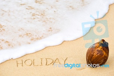 Inscription Of Word Holiday Written On Wet Yellow Beach Sand And… Stock Photo