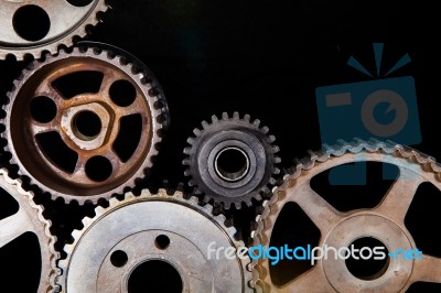 Interlocking Industrial  Cogwheels Top View On Black Background Stock Photo