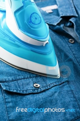 Ironing Denim Shirt Stock Photo