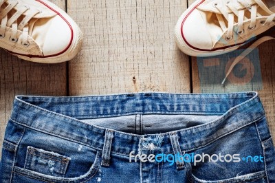 Jeans On The Old Wood Stock Photo