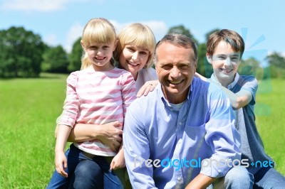 Joyful Family Of Four On A Bright Sunny Day Stock Photo